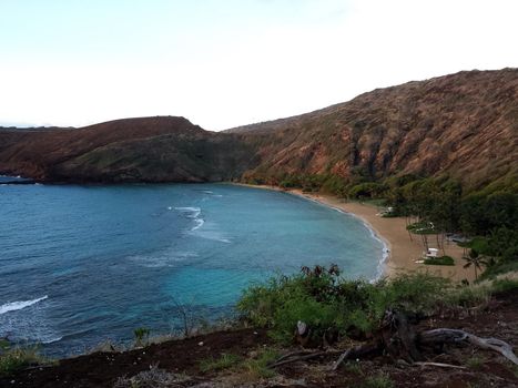 Waves roll into Hanamau Bay and Beach on Oahu, Hawaii.