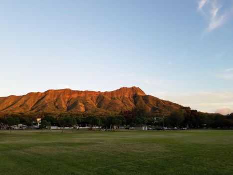 Kapiolani Park at during day with Diamond Head and clouds in the distance on Oahu, Hawaii.