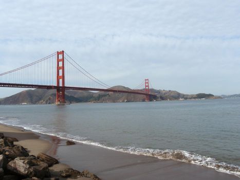 Beach and Golden Gate Bridge in the distance in San Francisco, California.