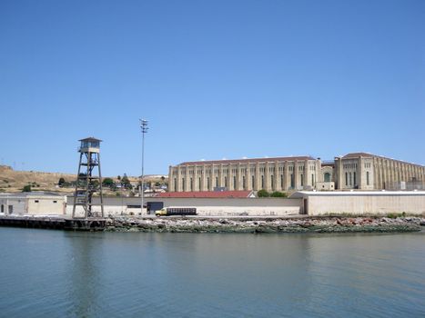 San Quentin State Prison shoreline in California taken from a passing ferry with lookout tower.