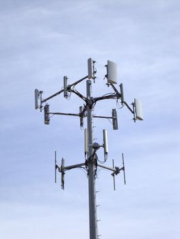 Cellphone Data Communication tower in blue sky with clouds in Oakland, California.