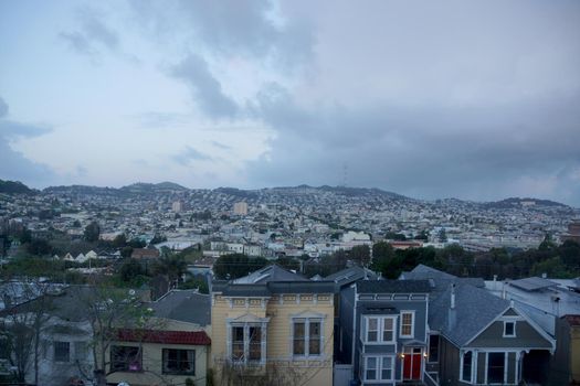 Aerial view of Houses, Cars. Cityscape, streets, and mountians of San Francisco in Potrero Hill Neighborhood with power-lines and cars parked on street.
