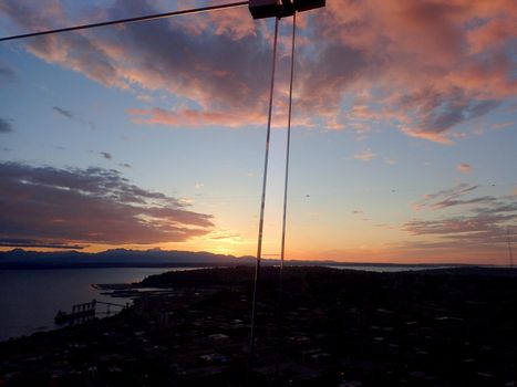 Seattle - May 19, 2019: Aerial of cityscape, Centennial Park, Puget Sound, and coastline at Dusk.  Seen from Space Needle.
