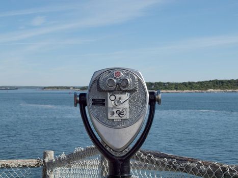 Portland, Maine -  May 28, 2010:  Coin operated binoculars look into the bay at Portland Head Lighthouse in Portland, Maine. 