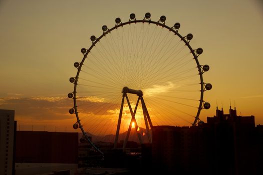 Las Vegas - June 27, 2015 - Sunrise through The High Roller Wheel light up at dawn at the center of the Las Vegas Strip on June 27, 2015 in Las Vegas. The High Roller is the world's largest observation wheel.