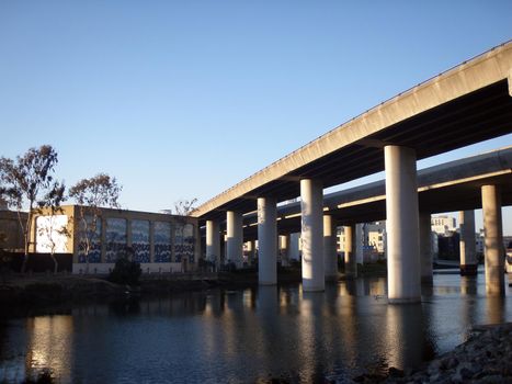 Overhead Highways on columns in the air as they go into the city of San Francisco as they hang over Mission Creek on a nice day in California. 