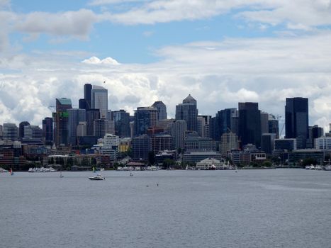 Union Lake with boats on the water and Downtown skyscrapers in the distance in Seattle, Washington, USA clouds in the sky.  June 2016.