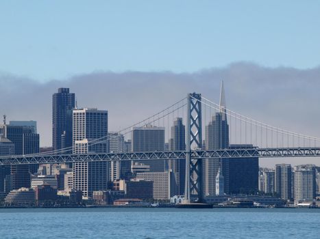 San Francisco -  August 16, 2010: Bay Bridge and Skyline with Ferry Building, downtown and Pyramid during the day,