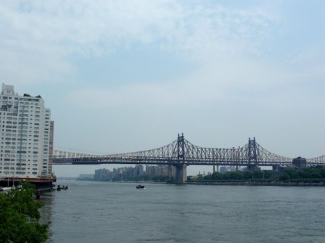 New York - June 1, 2007: The Queensboro Bridge, also known as the 59th Street Bridge – because its Manhattan end is located between 59th and 60th Streets – and officially named the Ed Koch Queensboro Bridge, is a cantilever bridge over the East River in New York City.