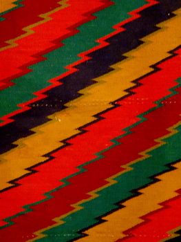 Zig-zag Pattern Red, Orange, Yellow, Green, Black, and blue Blanket/ Rug - Navajo Artist, made about 1885 of cotton and wool.                              
