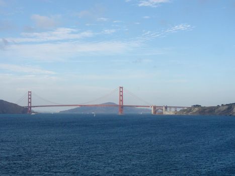 Golden Gate Bridge with sail boats in the bay in San Francisco, California.