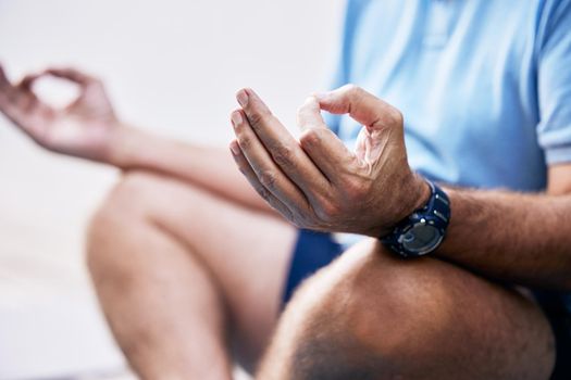Sharpening the mind-body connection. Closeup shot of an unrecognisable man meditating outdoors