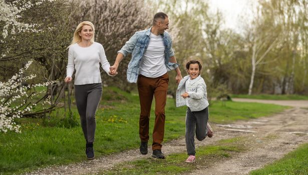 Young family with children and with dog having fun in nature.