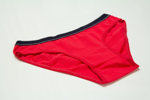 Red cotton panties on the white background. Women underwear. Top view.