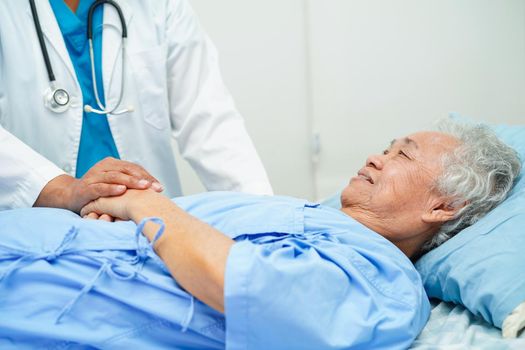 Doctor holding hands Asian elderly woman patient, help and care in hospital.