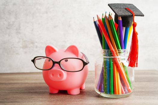 Graduation hat with colorful pencils on book with copy space, learning university education concept.