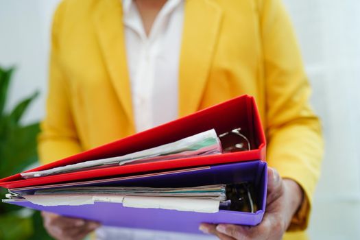Businessman working and prepare paperwork report data to analysis information in file binder at office.