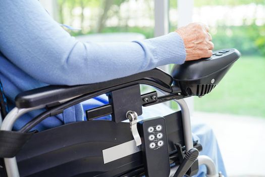 Asian elderly woman disability patient walk with walker in nursing hospital, medical concept.