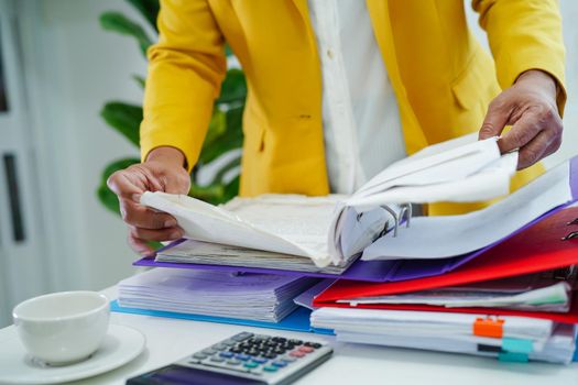 Businessman working and prepare paperwork report data to analysis information in file binder at office.