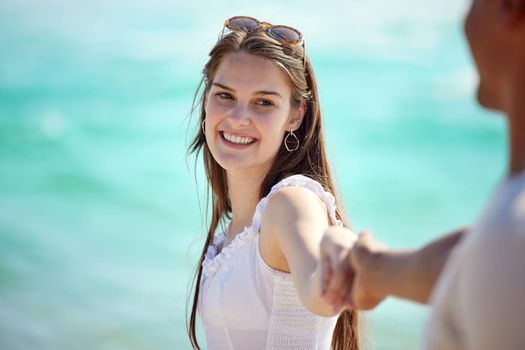 Ill walk hand in hand with you forever. a young couple enjoying a day at the beach