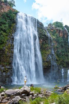 Panorama Route South Africa, Lisbon Falls South Africa, Lisbon Falls is the highest waterfall in Mpumalanga, South Africa. Caucasian men standing by a huge waterfall