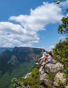 Panorama Route South Africa, Blyde river canyon with the three rondavels, view of three rondavels and the Blyde river canyon in South Africa. Asian women and Caucasian men on vacation in South Africa