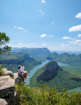 Panorama Route South Africa, Blyde river canyon with the three rondavels, view of three rondavels and the Blyde river canyon in South Africa. Asian women and Caucasian men on vacation in South Africa