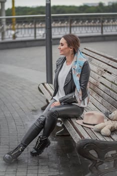woman sitting on a bench in the city