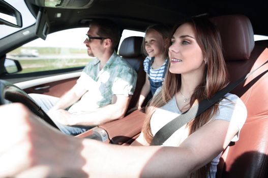 mom driving a family car .the concept of freedom and travel