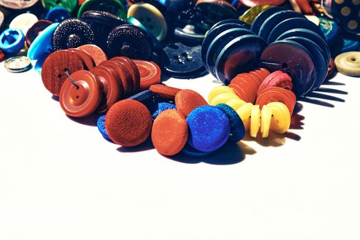 person whose occupation is making fitted clothes such as suits, pants, and jackets to fit individual customers. A large number of different multi-colored buttons