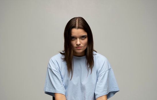 Negative human emotions and feelings. Grumpy young woman posing, frowning eyebrows, her look and grimace expressing anger, annoyance and dislike