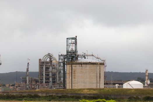 Old industrial oil refinery complex with metal structures and storage tanks, South Africa