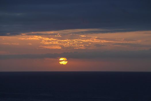 Sunrise over vast open ocean with overcast morning sky, Mossel Bay, South Africa