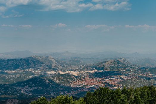 Panoramic view of idyllic mountain scenery in the Alps with fresh green meadows in bloom on a beautiful sunny day. Summer mountain landscape Landcscape hight mountains. Landscape in the fields.