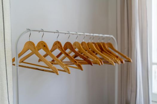 Close-up of wardrobe with wooden clothes hanger