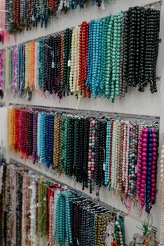 Shop window with necklaces and jewelry. Custome jewelry on display.Variety of colorful necklaces, bracelets, earrings, rings in window of costume jewelry store