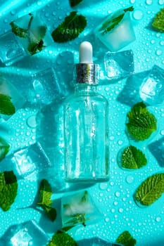 Bottle with cosmetics on a mint background with ice cubes and lemon. Selective focus. Spa.