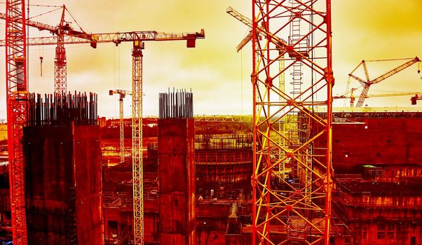 Cooling tower of an environmentally friendly nuclear power plant under construction and a lifting tower crane