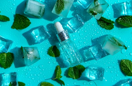 Bottle with cosmetics on a mint background with ice cubes and lemon. Selective focus. Spa.