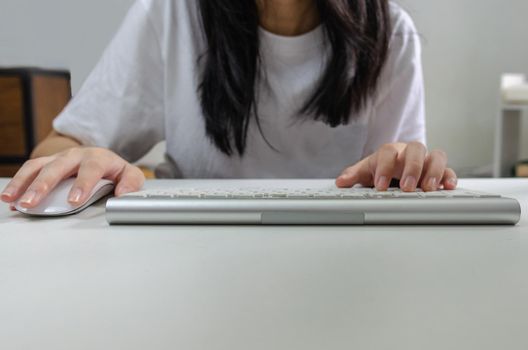 Female person holding mouse and keyboard computer. Technology internet information browsing online social media and network concept.