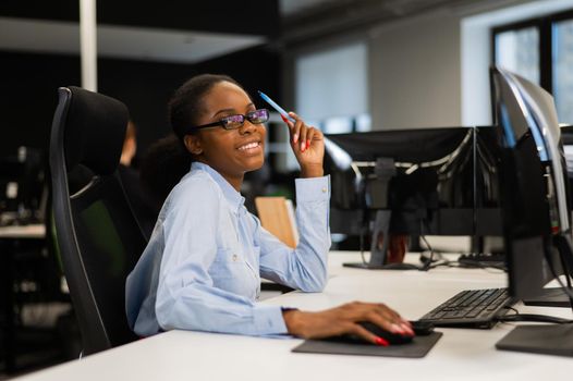 Portrait of an African young woman at a desk in the office