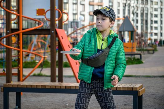 Caucasian boy exercise playing table tennis outdoors. Active leisure for children concept.