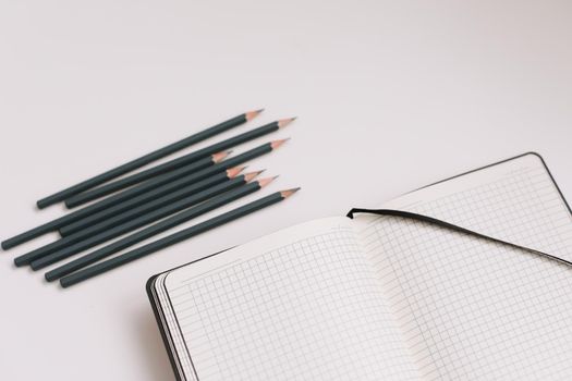 Back to school concept, school and office supplies, top view of notebook and pencils on white background, flat lay, copy space