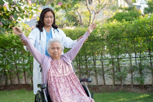 Asian senior or elderly old woman exercise with doctor in park, healthy strong medical concept.