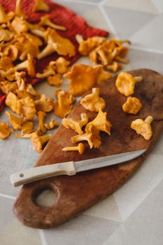 chanterelle mushrooms on a cutting board on the kitchen table
