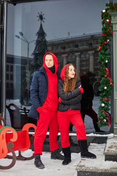 young happy family, a guy and a girl spend the day near the cafe, the guy hugs the girl