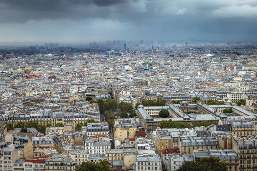Panoramic view above Paris from Sacre Couer in Montmartre with dramatic storm clouds sky, France