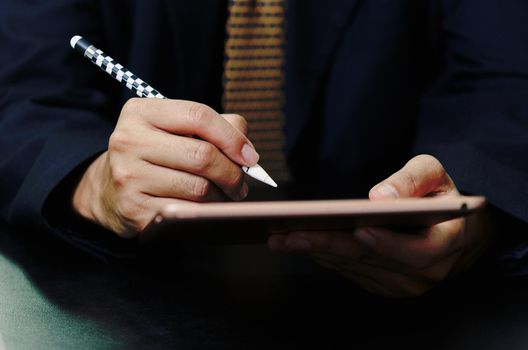 Business man sign digital online tablet contract in application on desk.