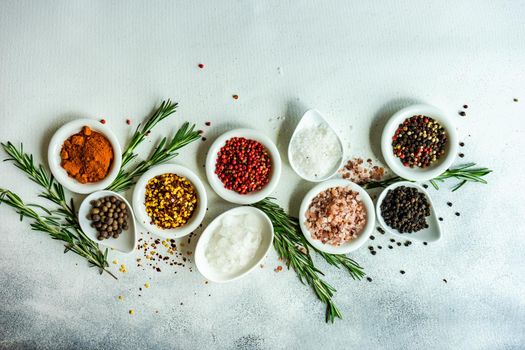 Spices in the bowls as a cooking frame on concrete table