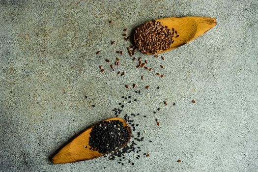 Overhead view of vintage wooden spoons with black sesame and flax seeds